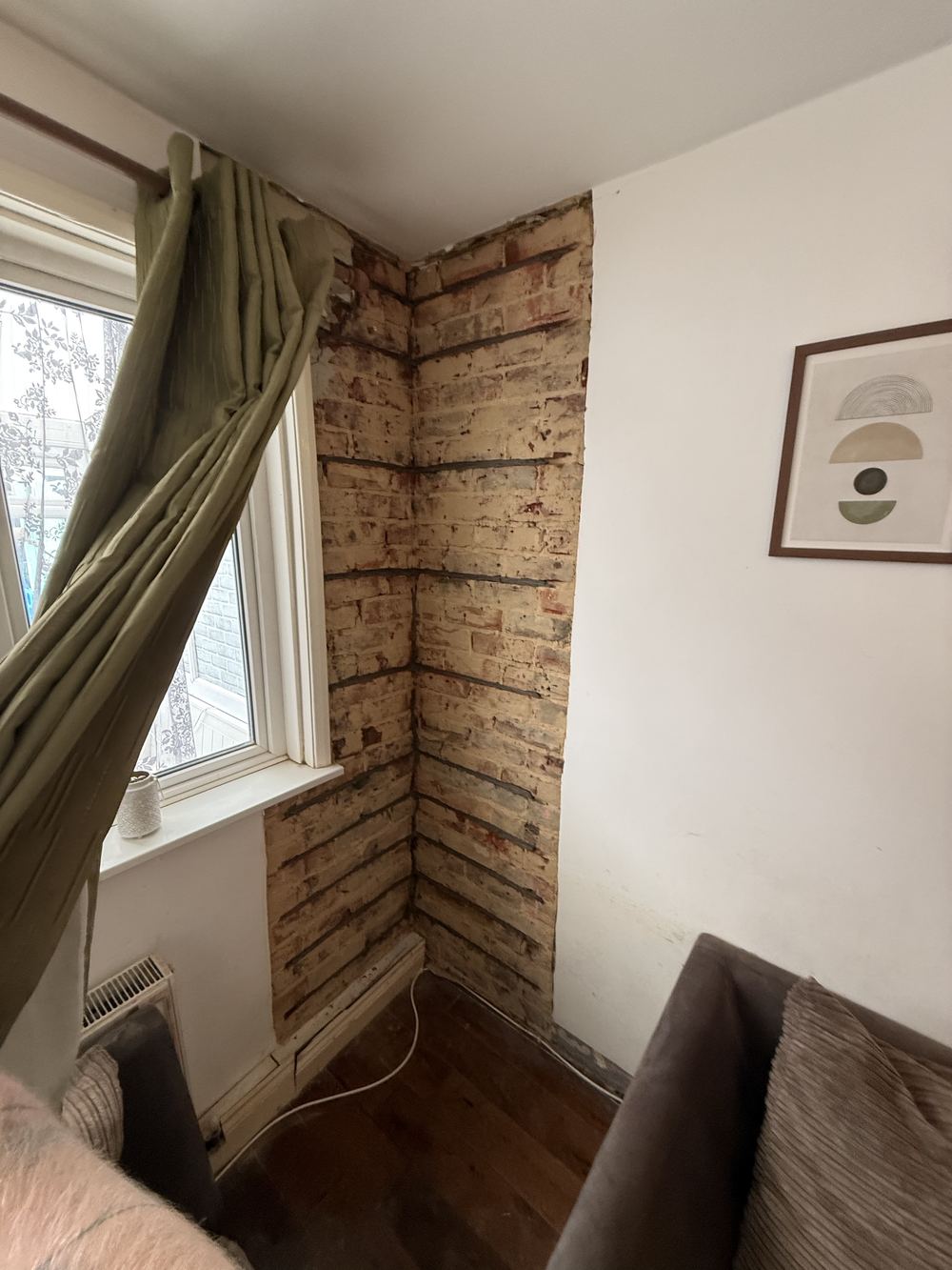 Helical bar crack stitching repair to an internal corner crack in Southampton, plaster removed showing the reinforced brickwork