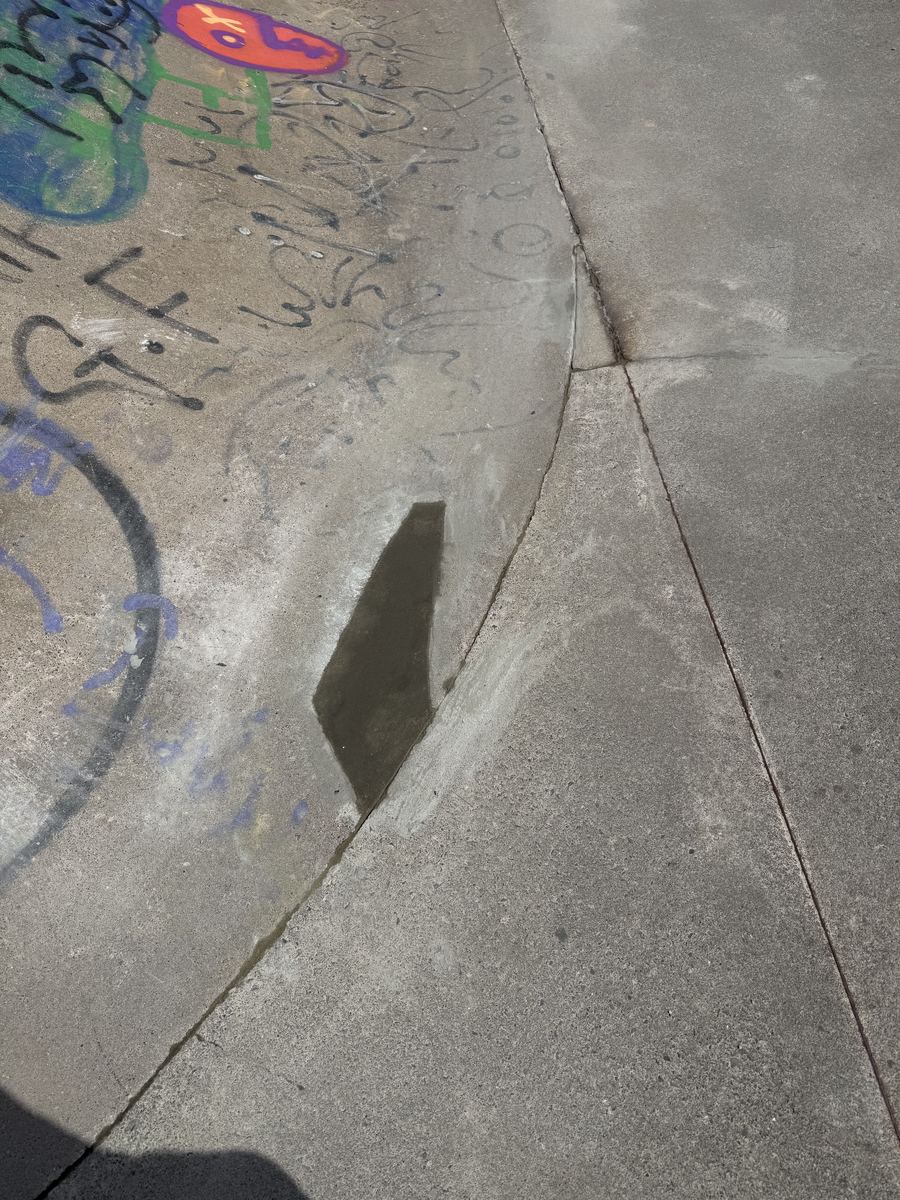 Concrete repair work in progress at a public skatepark