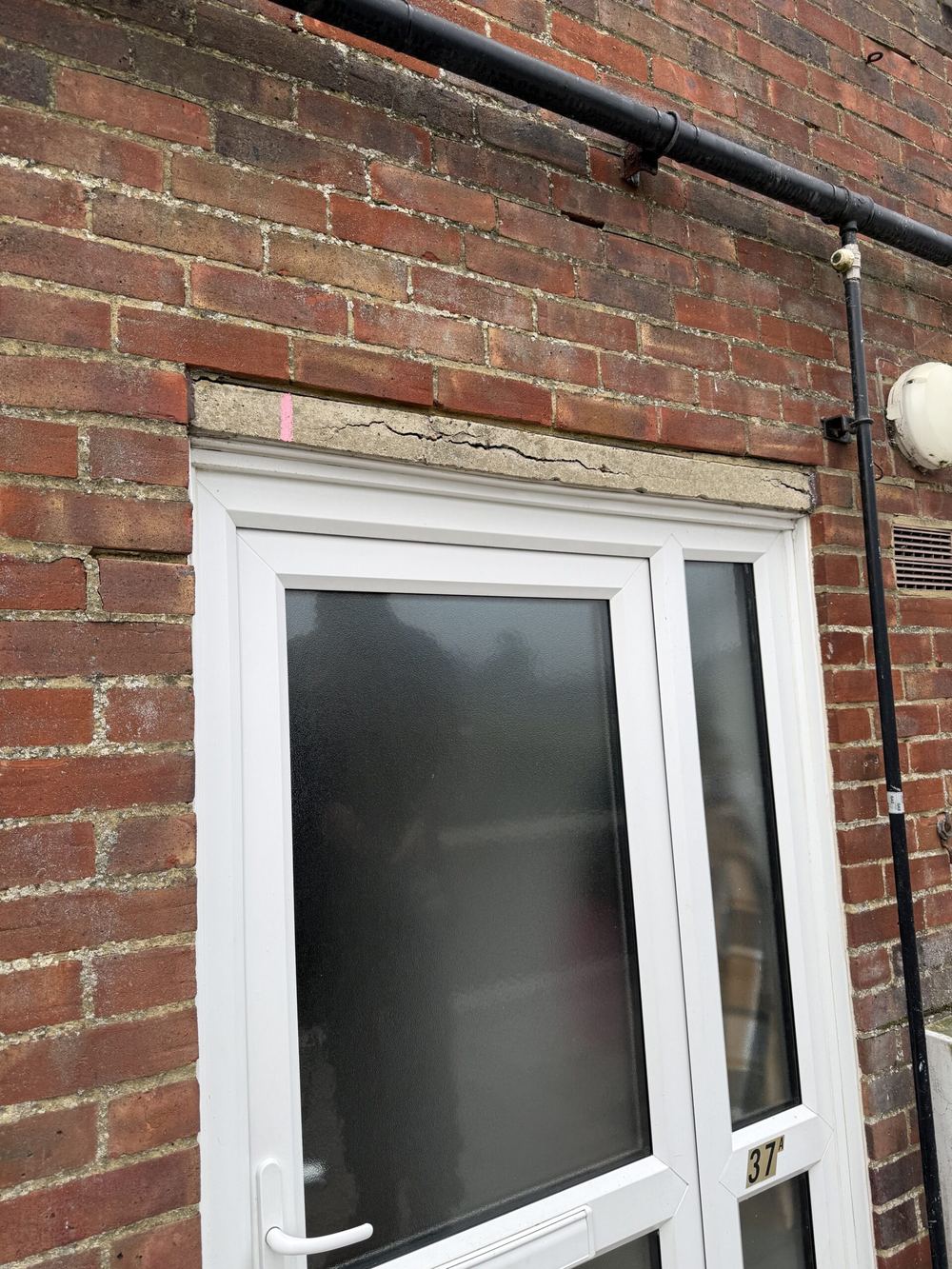 Cracked concrete boot lintel before repair, Polegate, Sussex